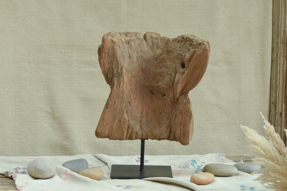 Ekaurr Akriti fragment of a traditional Indian okhali mortar repurposed as an abstract sculptural decor piece on a minimalist iron stand, textured organic home decor with a story