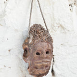 Close-up detail of Ekaurr Ancestral Echo wall mask showing hand-carved surface texture and aged earthy finish