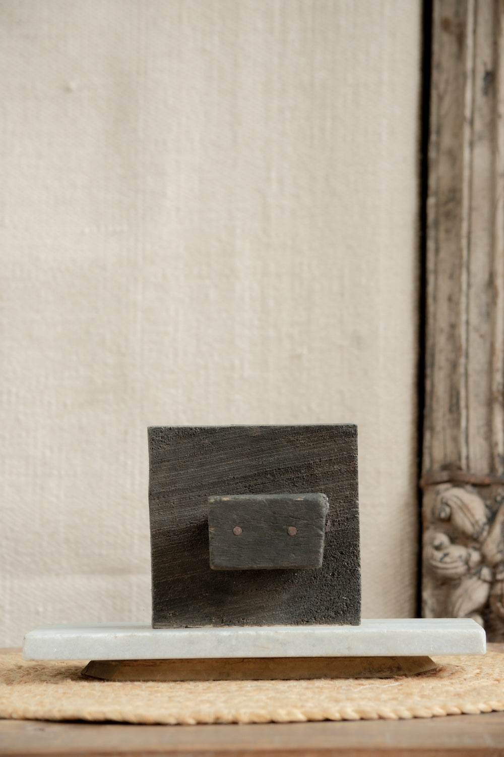 Ekaurr Artistry Print Block on Marble Base styled in a home décor vignette, showing hand-carved woodwork patina and natural imperfections with marble contrast base