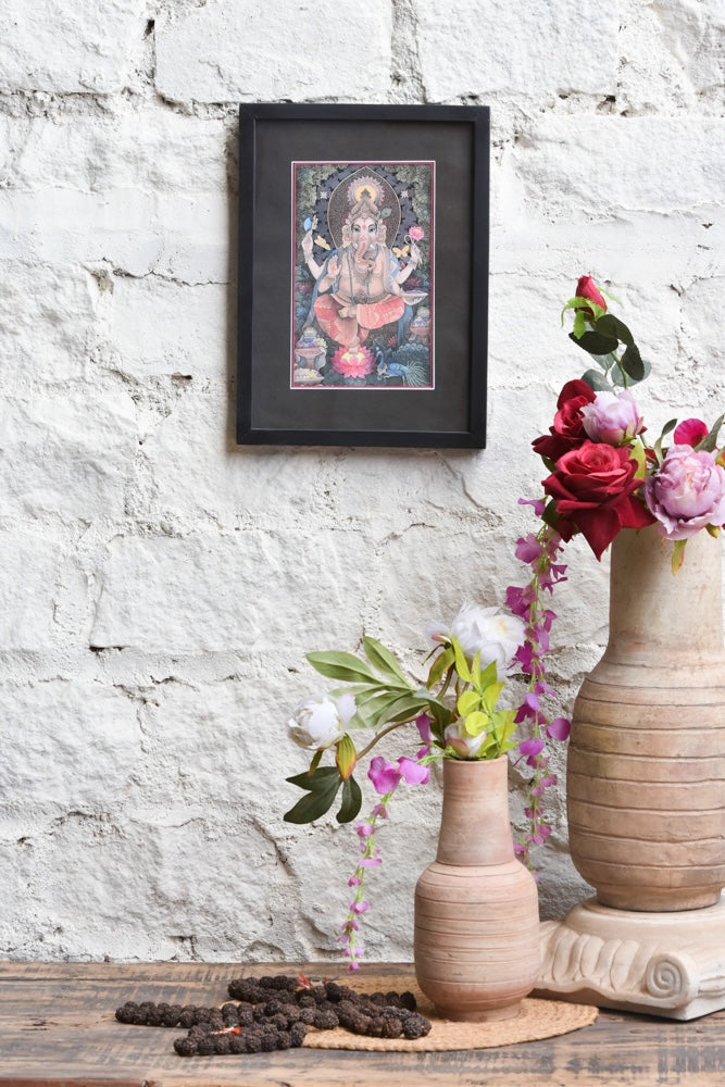 Ekaurr Blessings of Ganesha framed wall art depicting Lord Ganesha in vibrant hues with sacred symbols and ornamental detailing set against a black mount, spiritual home decor for altars meditation corners and sacred spaces