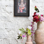 Ekaurr Blessings of Ganesha framed wall art depicting Lord Ganesha in vibrant hues with sacred symbols and ornamental detailing set against a black mount, spiritual home decor for altars meditation corners and sacred spaces