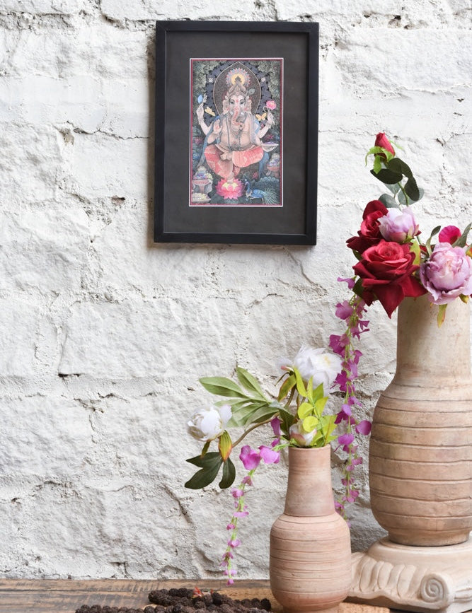 Ekaurr Blessings of Ganesha framed wall art depicting Lord Ganesha in vibrant hues with sacred symbols and ornamental detailing set against a black mount, spiritual home decor for altars meditation corners and sacred spaces
