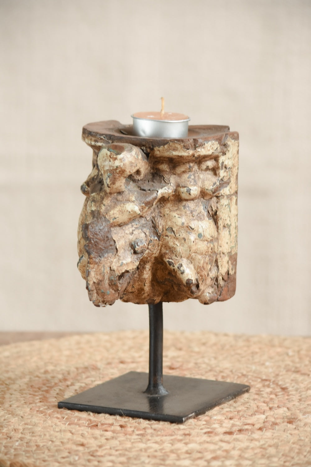 Ekaurr Carved Candle Stand in Distressed Finish with vintage hand-carved wood on iron base, earthy rustic candle holder celebrating aged craftsmanship and natural patina