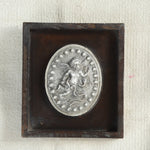 Ekaurr Ceramic Tile Wall Art – The Classical Cherub Medallion, embossed ceramic cherub motif framed in warm-toned wooden shadowbox, heritage-inspired decorative wall piece