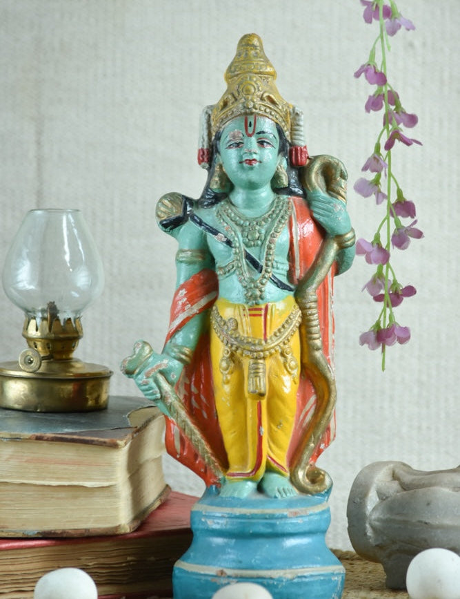 Ekaurr Cosmic Preserver Lord Vishnu hand-painted idol with conch and mace in bright green yellow and red with ornate crown, traditional devotional figurine for home altars and decor
