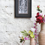 Ekaurr Divine Grace framed black-and-white wall art of Goddess Lakshmi in intricate traditional illustration style set against a matte black border, spiritual home decor for sacred and meditative spaces