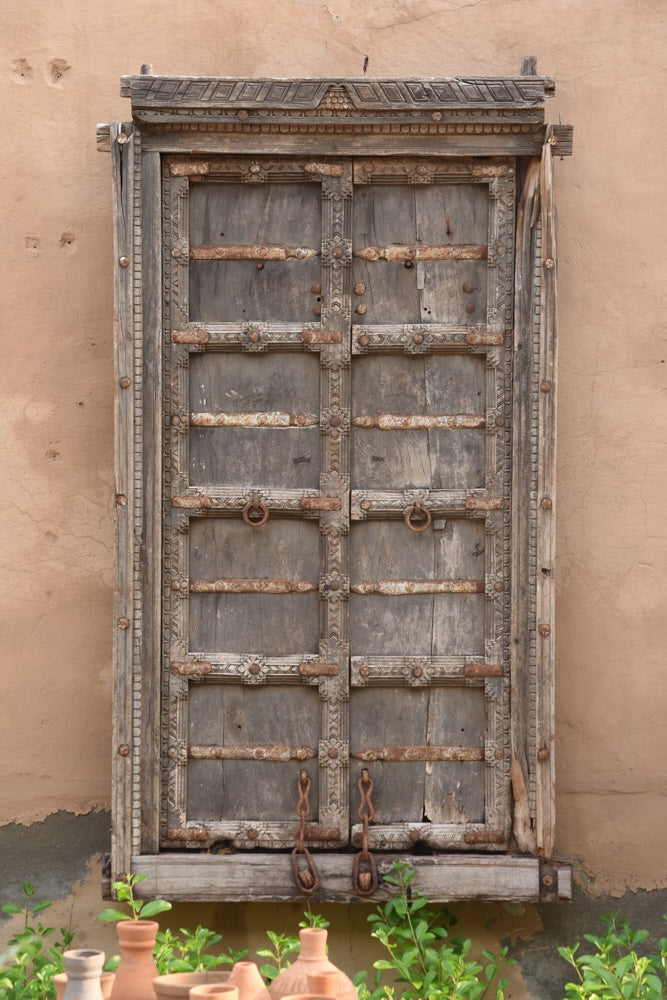 Ekaurr Dwaar Memoir antique salvaged Rajasthan teakwood door frame with hand-carved floral motifs and rusted iron accents, architectural heritage wall art and statement décor