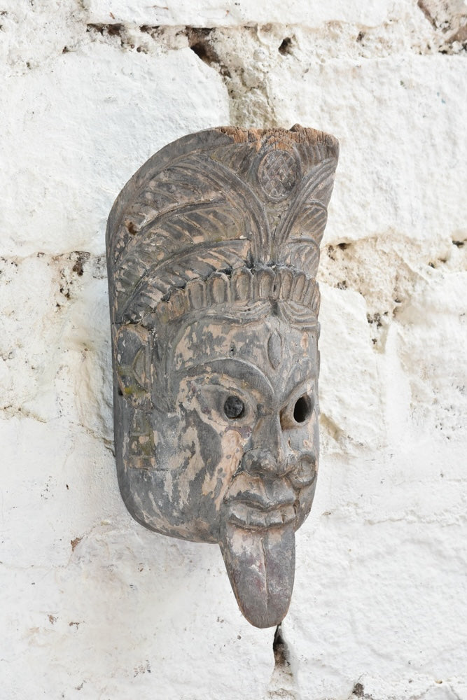 Ekaurr Fierce Protector decorative mask displayed on a wall, showcasing its powerful carved features and deep earthy tones