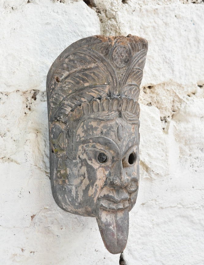 Ekaurr Fierce Protector decorative mask displayed on a wall, showcasing its powerful carved features and deep earthy tones