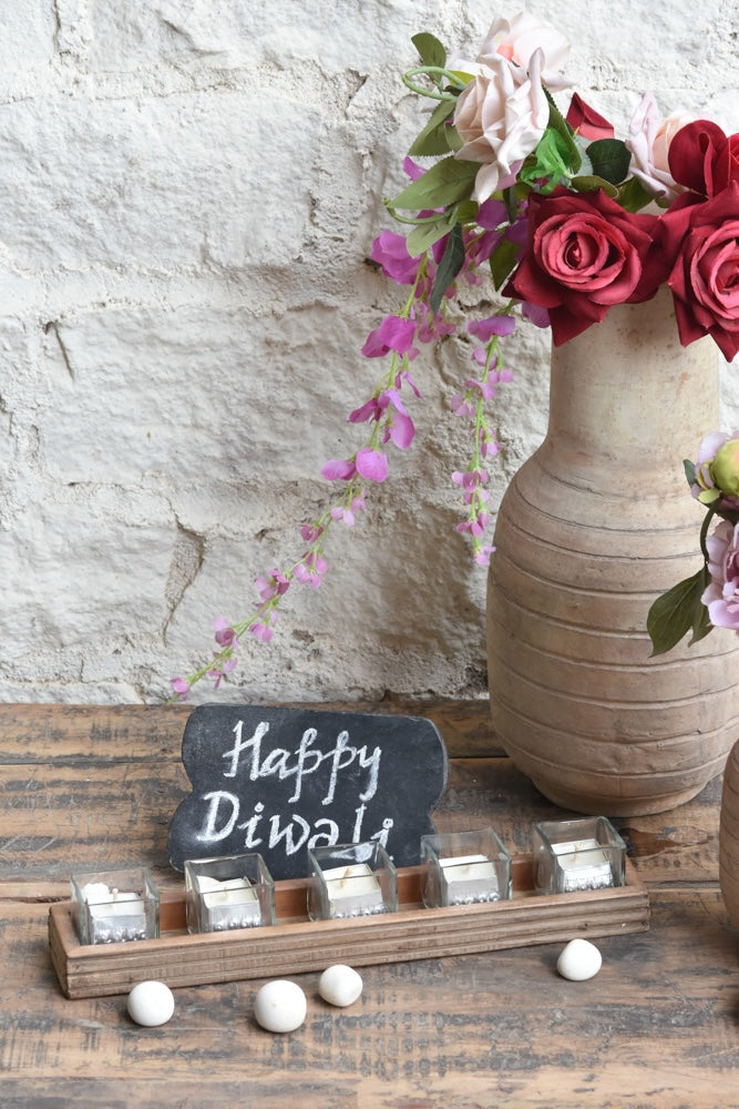 Ekaurr Flame Gift Set curated artisan gift of an emblem chalkboard five glass tealight cups with candles in aluminium containers a handcrafted wooden tray a muslin pouch of 24 decorative stones and greeting card at Rs.5100, thoughtful sustainable gifting for home ambience and festive occasions