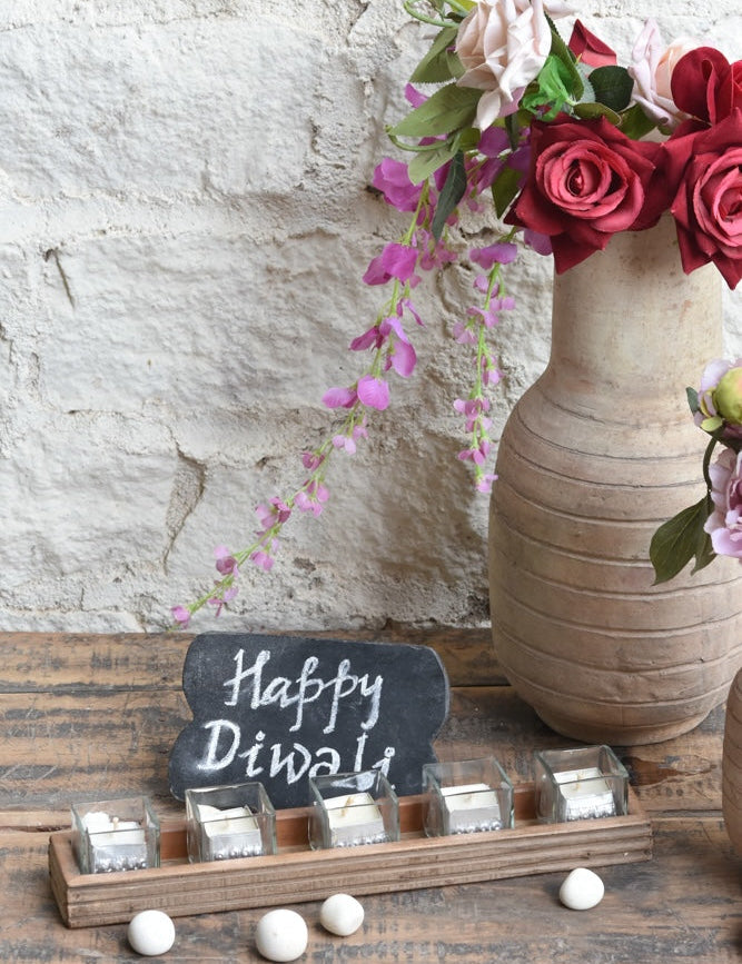Ekaurr Flame Gift Set curated artisan gift of an emblem chalkboard five glass tealight cups with candles in aluminium containers a handcrafted wooden tray a muslin pouch of 24 decorative stones and greeting card at Rs.5100, thoughtful sustainable gifting for home ambience and festive occasions