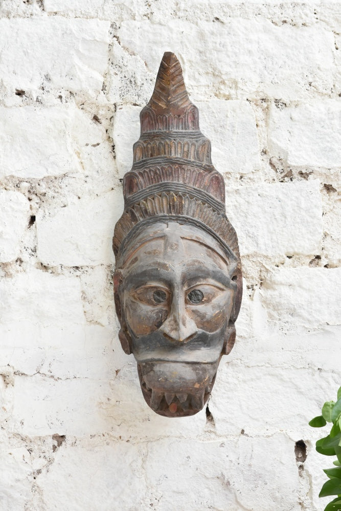 Ekaurr Guardian Spirit Mask close detail showing hand-carved headdress and facial features in aged natural wood