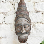 Ekaurr Guardian Spirit Mask close detail showing hand-carved headdress and facial features in aged natural wood