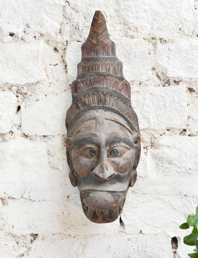 Ekaurr Guardian Spirit Mask close detail showing hand-carved headdress and facial features in aged natural wood