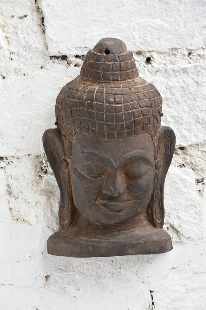 Ekaurr Hand Carved Buddha Wall Sculpture close-up showing soft carved contours, meditative smile and natural aged wood finish