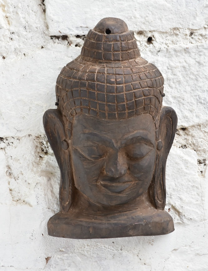 Ekaurr Hand Carved Buddha Wall Sculpture close-up showing soft carved contours, meditative smile and natural aged wood finish
