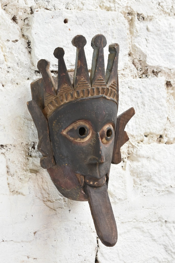 Ekaurr Kali Roar Tribal Tongue Mask detail showing hand-carved crown motifs, expressive tongue and aged reclaimed wood patina