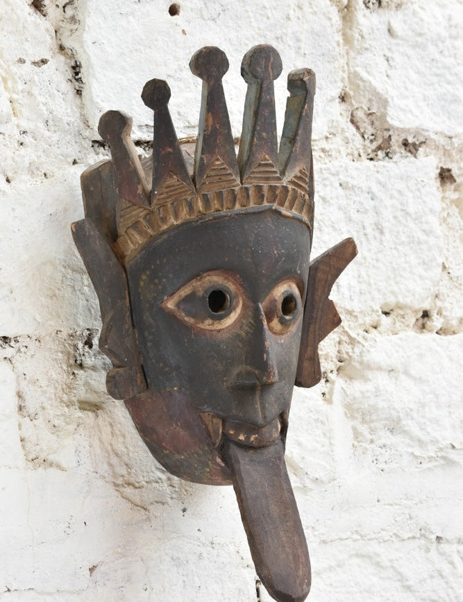 Ekaurr Kali Roar Tribal Tongue Mask detail showing hand-carved crown motifs, expressive tongue and aged reclaimed wood patina
