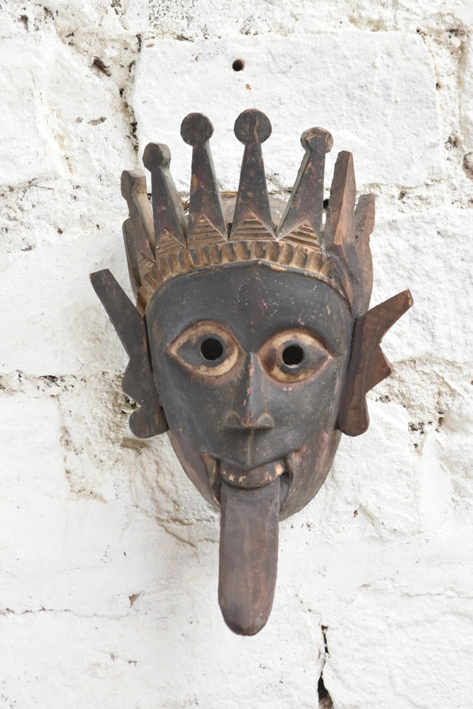 Ekaurr Kali Roar Tribal Tongue Mask hand-carved wooden wall mask with bold extended tongue, crown and fierce expression inspired by Kali, vintage one-of-a-kind décor