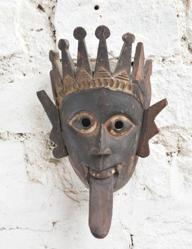 Ekaurr Kali Roar Tribal Tongue Mask hand-carved wooden wall mask with bold extended tongue, crown and fierce expression inspired by Kali, vintage one-of-a-kind décor