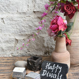 Ekaurr Little Joys Gift Set curated artisan gift of an emblem chalkboard a vintage print block cutlery stand a print block bottle opener two hand-poured candles in aluminium containers four decorative pebble stones and a greeting card at Rs.5100, playful sustainable gifting celebrating Indian print block craft
