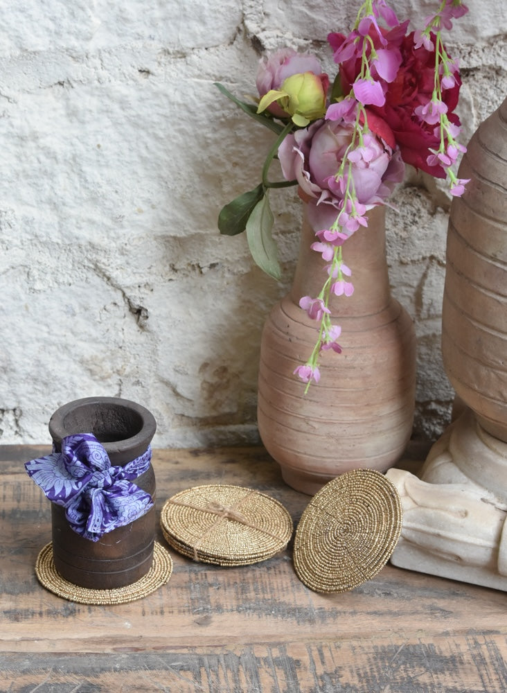 Ekaurr Morning Elegance Gift Set curated artisan gift set of four hand-beaded gold weave coasters paired with a reclaimed wood pot adorned with a fabric bow and complimentary greeting card, elegant sustainable gifting for home and table styling