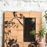 Ekaurr Morning Perch Mirror hand-painted bird on a blooming branch across individually grained reclaimed wood tiles framing a clear mirror panel at 30x30 inches, artisan one-of-a-kind wall mirror for living rooms and entryways