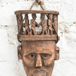 Ekaurr Peace Maker Tribal Bond Mask detail view highlighting hand-chiselled tribal figures and natural wood character
