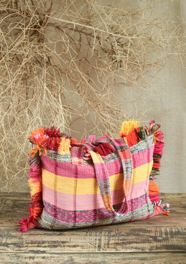 Ekaurr Pink Threaded Tales Bag with Fringes handcrafted kantha or patchwork fabric tote in pink tones with tassel fringe detailing, artisan Indian textile accessory for everyday use and boho-inspired conscious styling