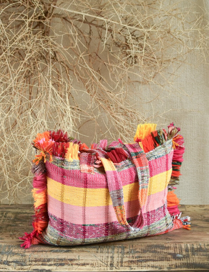 Ekaurr Pink Threaded Tales Bag with Fringes handcrafted kantha or patchwork fabric tote in pink tones with tassel fringe detailing, artisan Indian textile accessory for everyday use and boho-inspired conscious styling