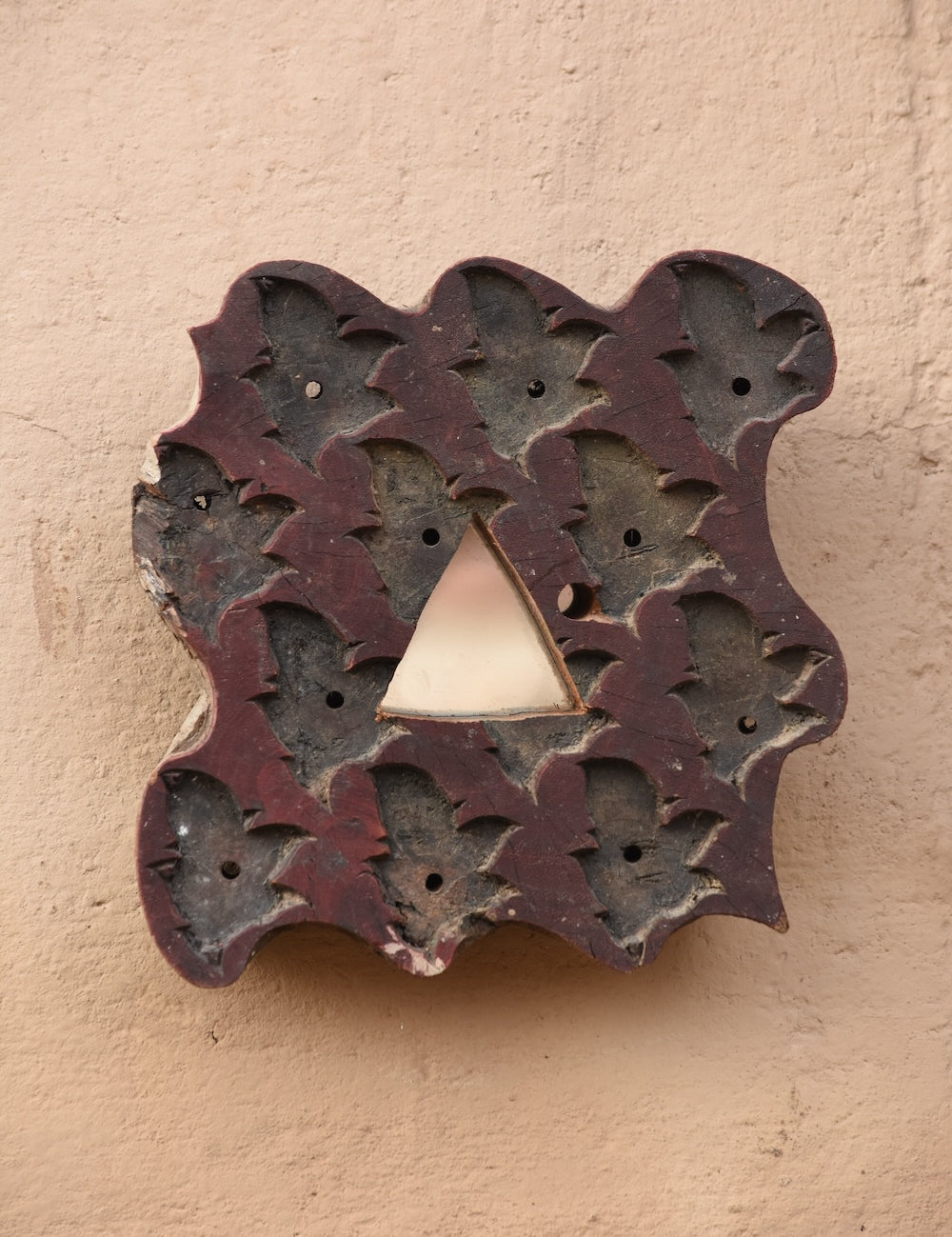 Close-up of Ekaurr Print Block Mirror showing intricate hand-carved motifs and aged patina on repurposed wooden printing block