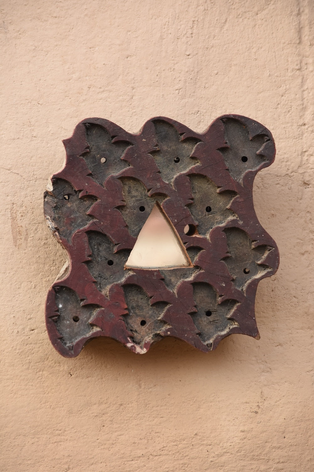 Close-up of Ekaurr Print Block Mirror showing intricate hand-carved motifs and aged patina on repurposed wooden printing block