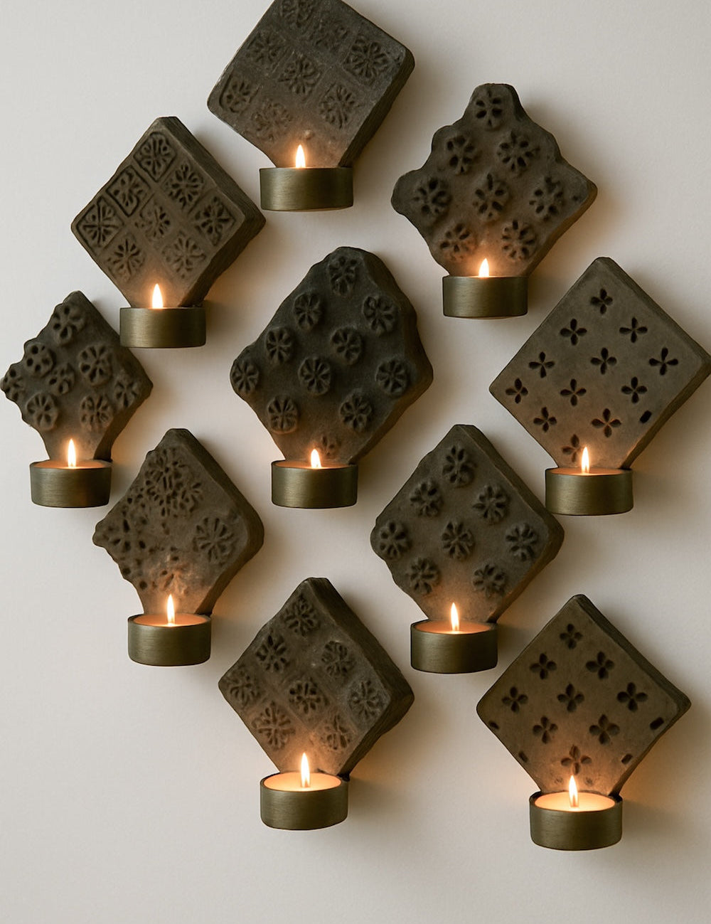 Ekaurr Hand Carved Print Block Wall Sconces with Brass Bowls set of 9 vintage wooden print blocks mounted as wall sconces each holding a brass bowl for tea lights or botanicals, artisan heritage wall display for curated home interiors