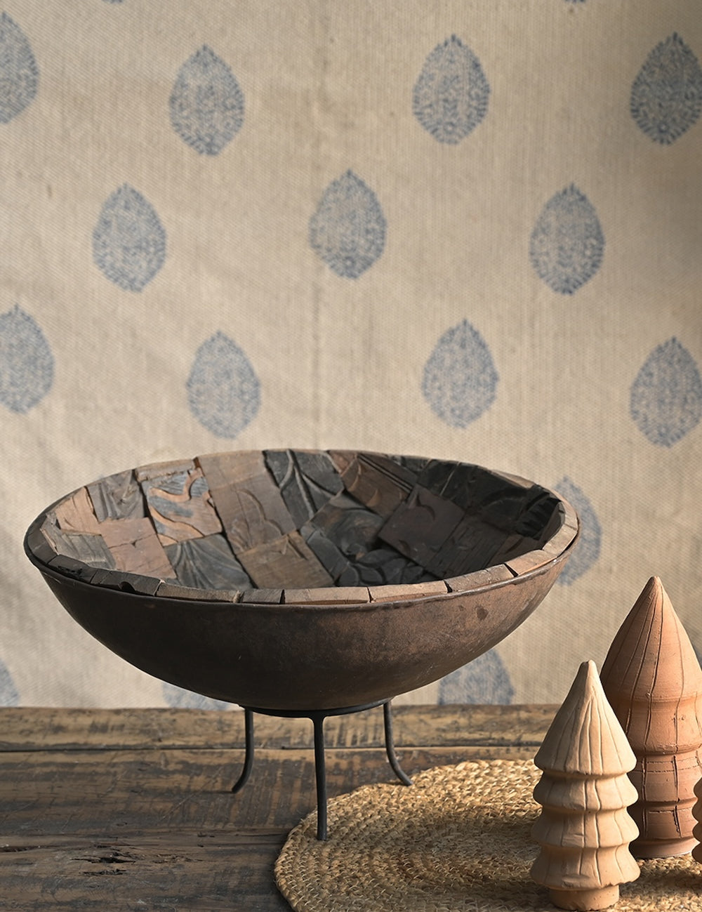 Close-up detail of Ekaurr iron bowl interior lined with antique printing blocks featuring carved artisan textures