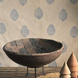Close-up detail of Ekaurr iron bowl interior lined with antique printing blocks featuring carved artisan textures