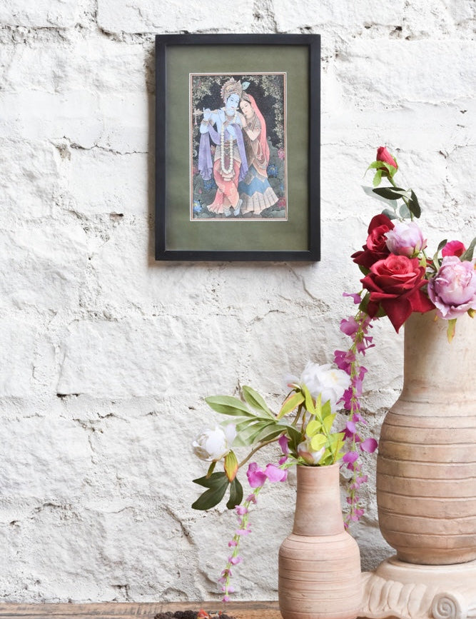 Ekaurr Radha Krishna Eternal Melody framed wall art depicting Radha and Krishna in a devotional composition with Krishna playing the flute set in a black frame with olive mount, spiritual home decor for altars and living rooms