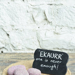 Ekaurr Ruby Essence Gift Set curated artisan gift set including a ruby-cladded natural stone paperweight and a rustic wooden emblem chalkboard with complimentary greeting card, luxury sustainable gifting for desks and home styling