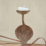 Ekaurr Rustic Snake Iron Candles styled with lit candles showing the snake form silhouette in warm candlelight against a home setting
