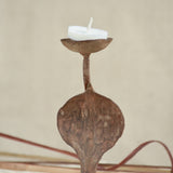 Ekaurr Rustic Snake Iron Candles styled with lit candles showing the snake form silhouette in warm candlelight against a home setting
