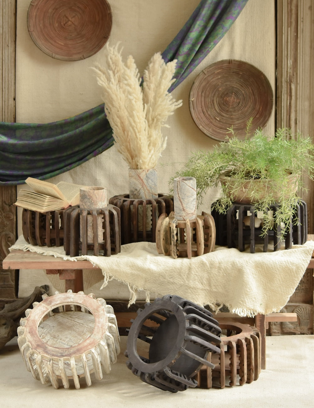 Ekaurr The Sanchey Circles EDIDA award-nominated multi-purpose décor showing reclaimed wood circular bases with vintage brick emblem halves, sustainable art installation