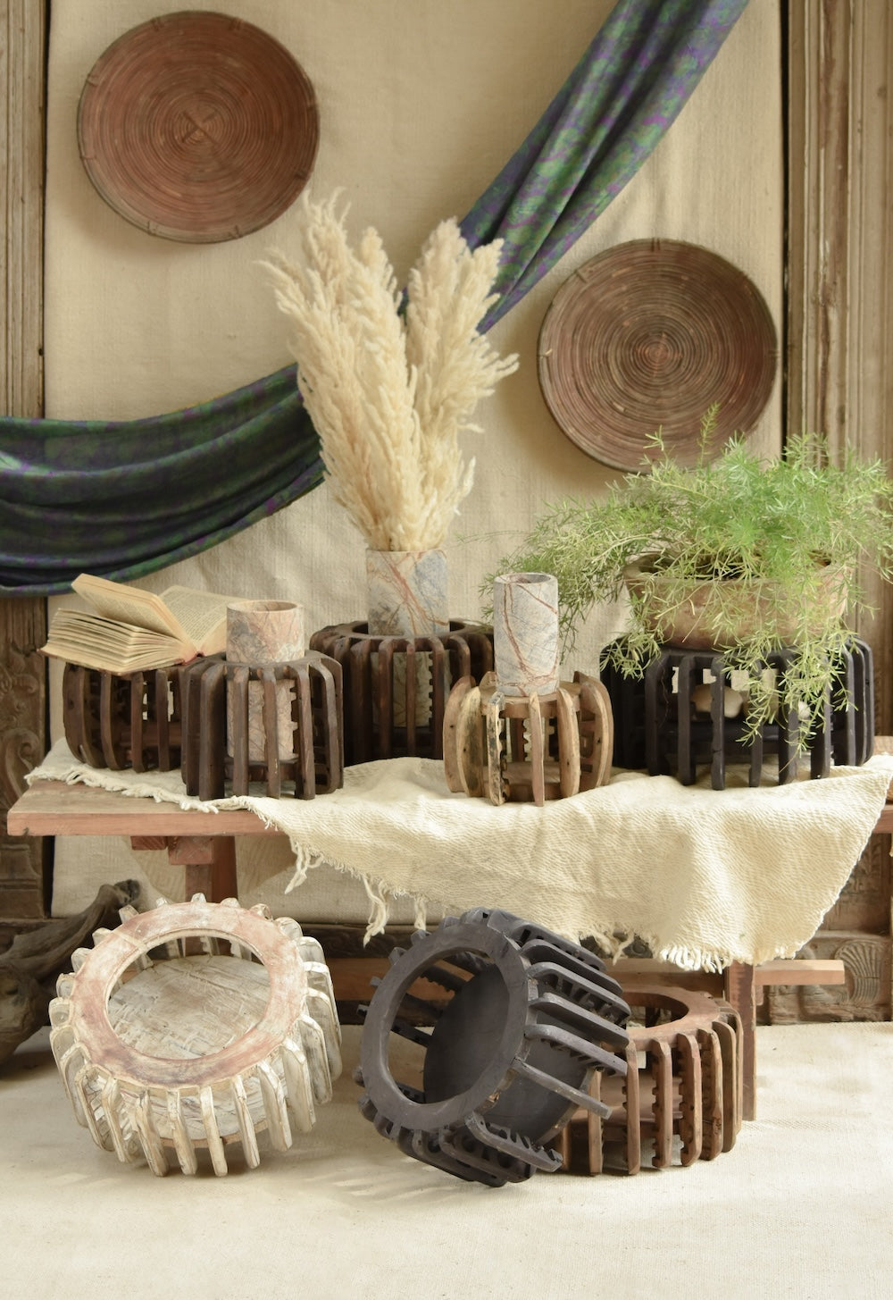 Ekaurr The Sanchey Circles EDIDA award-nominated multi-purpose décor showing reclaimed wood circular bases with vintage brick emblem halves, sustainable art installation
