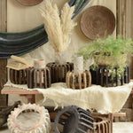 Ekaurr The Sanchey Circles EDIDA award-nominated multi-purpose décor showing reclaimed wood circular bases with vintage brick emblem halves, sustainable art installation