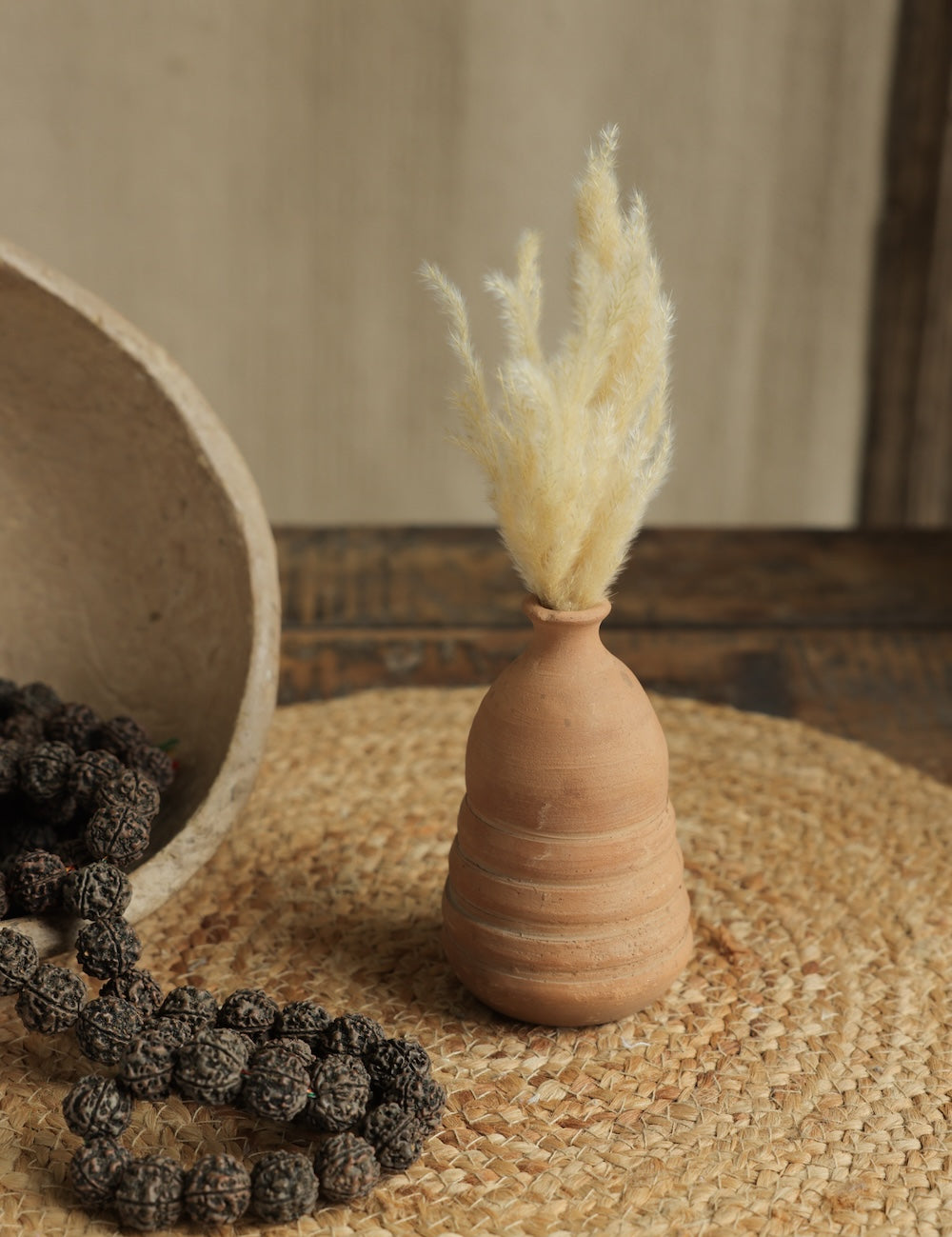 Ekaurr Set of 7 Terracotta Planters styled on a console with plants and frames handmade women empowerment decor