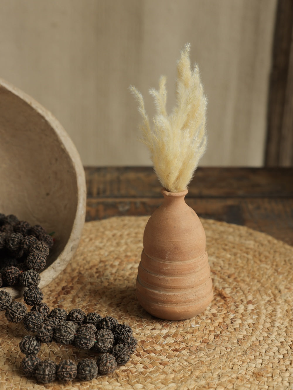 Ekaurr Set of 7 Terracotta Planters styled on a console with plants and frames handmade women empowerment decor