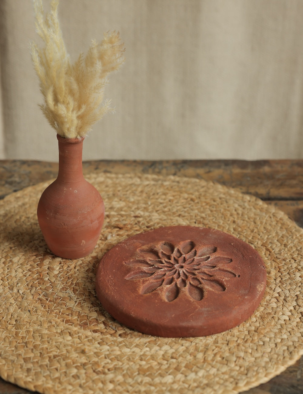 Ekaurr Terracotta Flower Design Riser handcrafted clay display stand with raised floral motif surface carving, earthy artisan pedestal for small sculptures candles or home decor accents