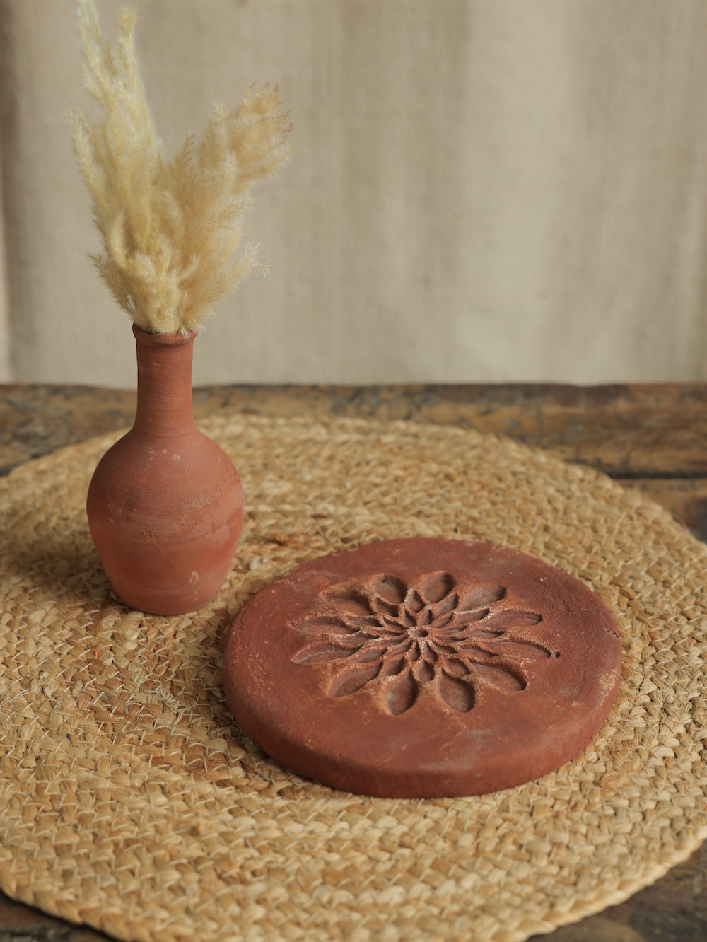 Ekaurr Terracotta Flower Design Riser handcrafted clay display stand with raised floral motif surface carving, earthy artisan pedestal for small sculptures candles or home decor accents