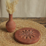Ekaurr Terracotta Flower Design Riser handcrafted clay display stand with raised floral motif surface carving, earthy artisan pedestal for small sculptures candles or home decor accents