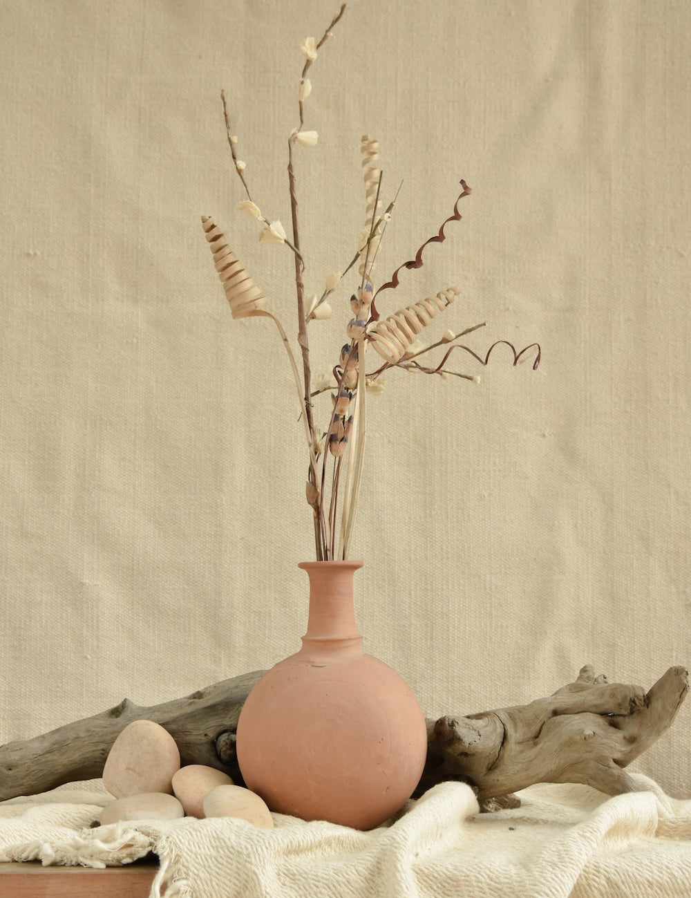 Ekaurr Terracotta Vase with rounded body and slender neck, handmade in unglazed natural clay with fabric iduni ring for stability, rustic artisan vase for floral or shelf styling