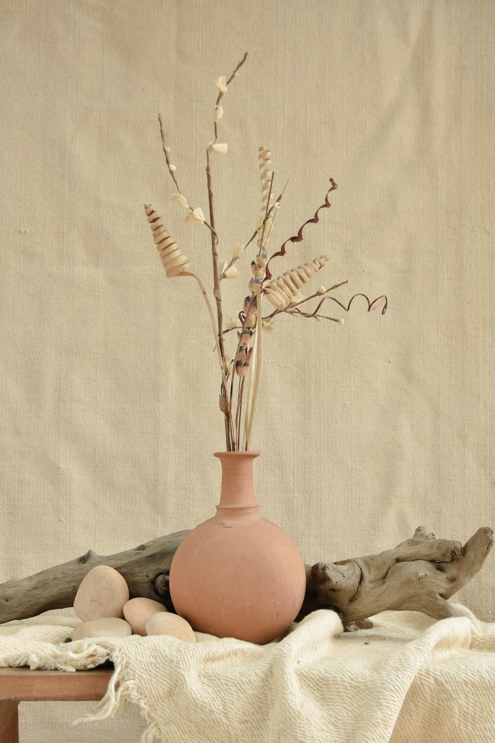 Ekaurr Terracotta Vase with rounded body and slender neck, handmade in unglazed natural clay with fabric iduni ring for stability, rustic artisan vase for floral or shelf styling