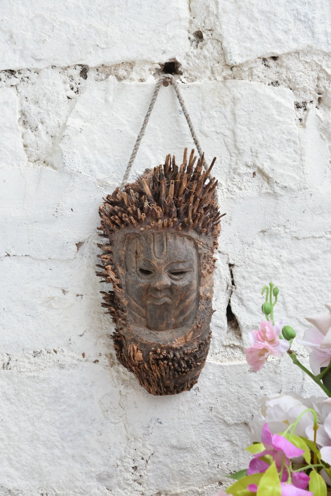 Ekaurr The Flame Keeper Mask, hand-carved aged wood tribal mask with flame-like protrusions and forehead symbol, one-of-a-kind vintage ritual wall art
